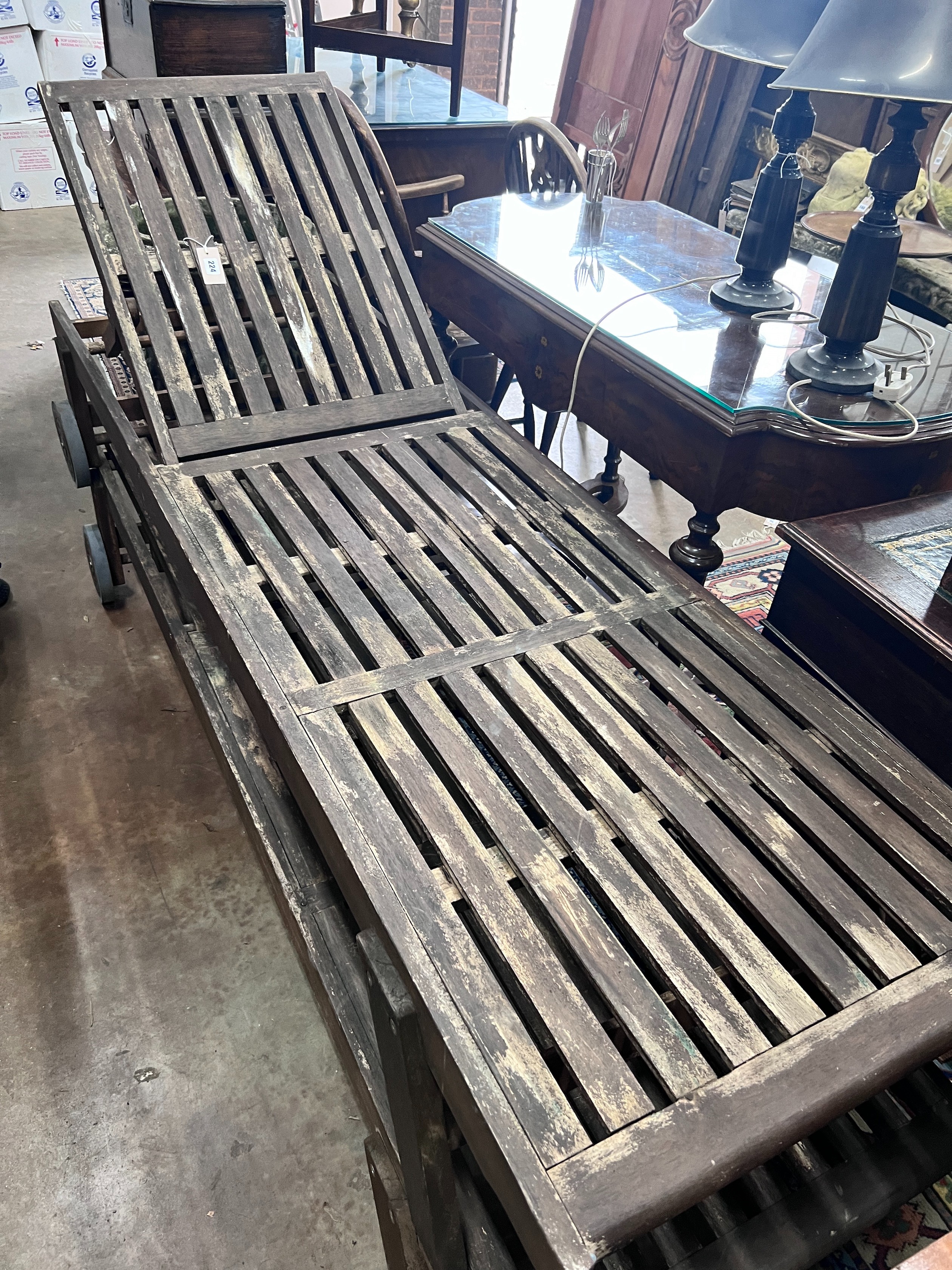 A pair of weathered teak steamer chairs, length 197cm *Please note the sale commences at 9am.